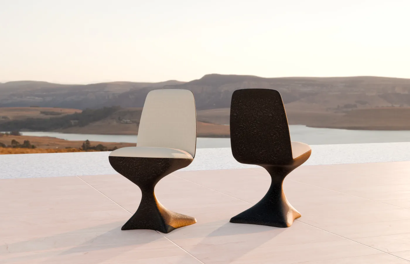 Alyna chairs in volcanic texture on outdoors by a pool overlooking a natural landscape.