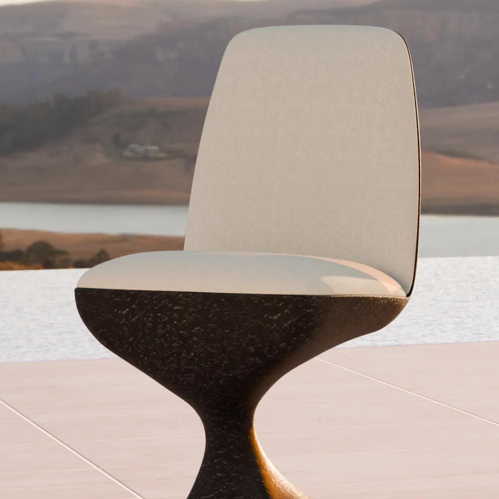 Detail of Alyna chair with volcanic textured base and upholstered seat outdoors.