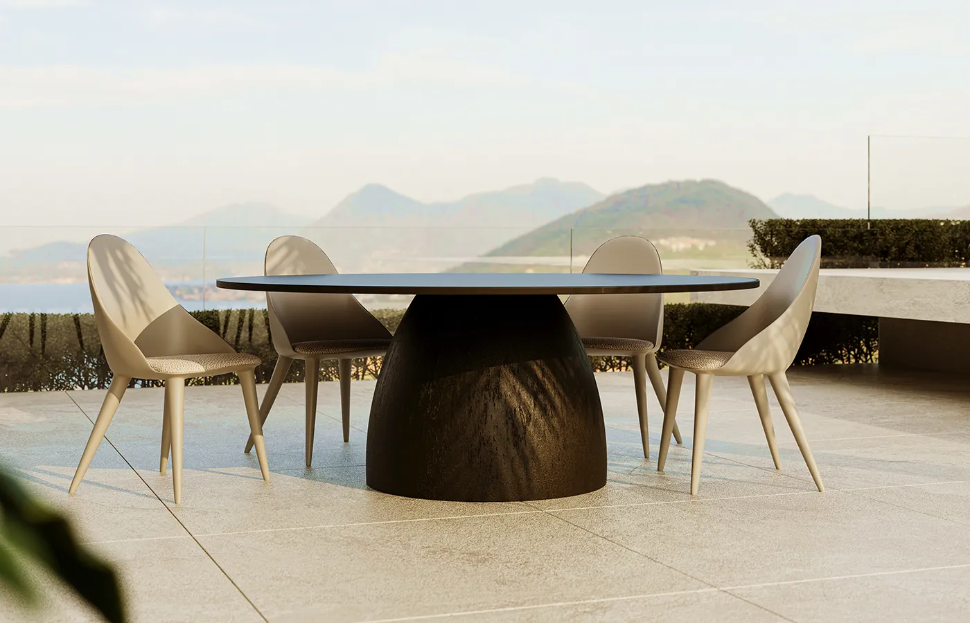 Barrel round dining table on an outdoor terrace, with a dark volcanic texture central base and coastal view in the background.