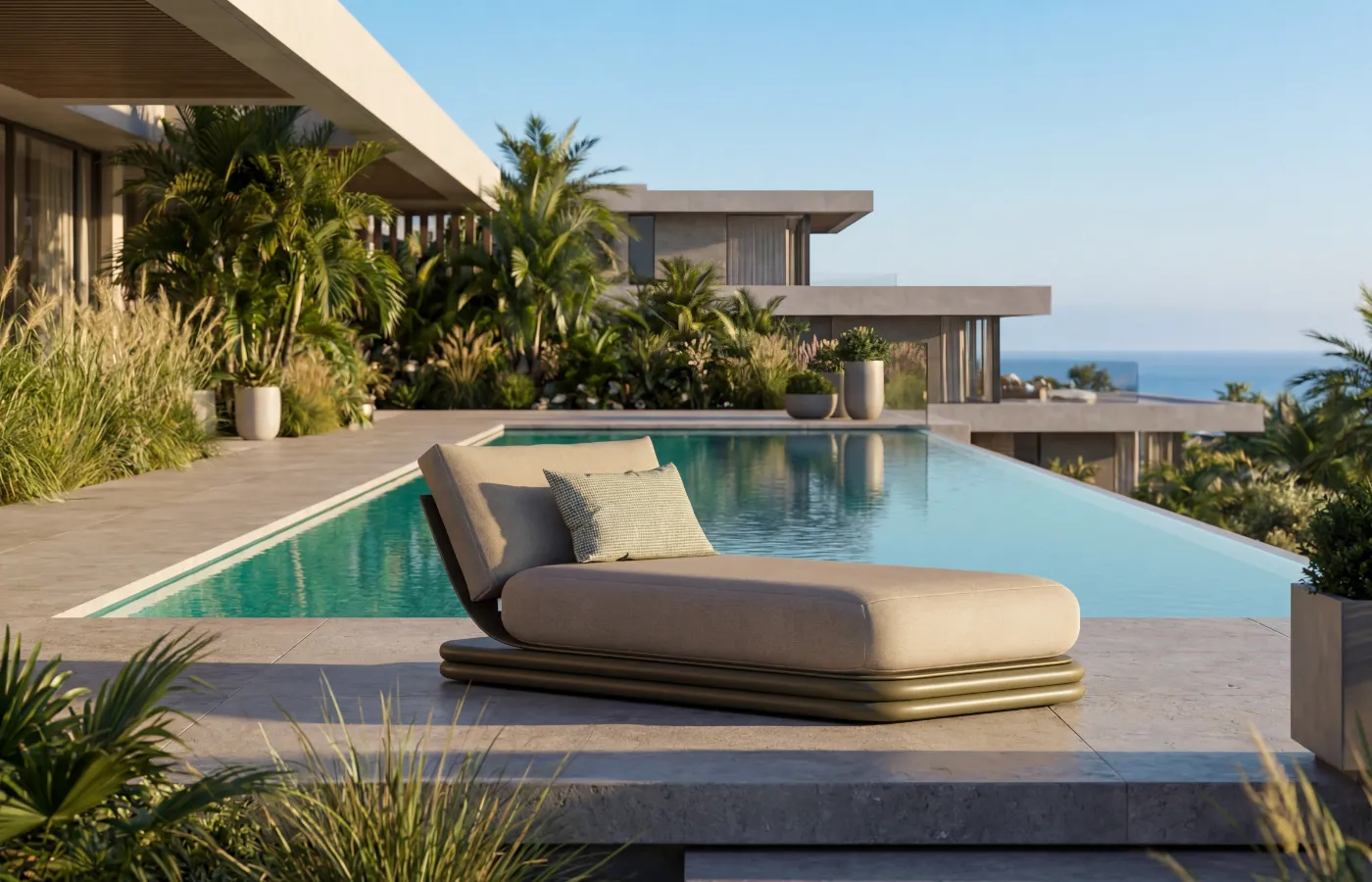 Green Capri chaise longue by a pool in a modern home with surrounding garden.