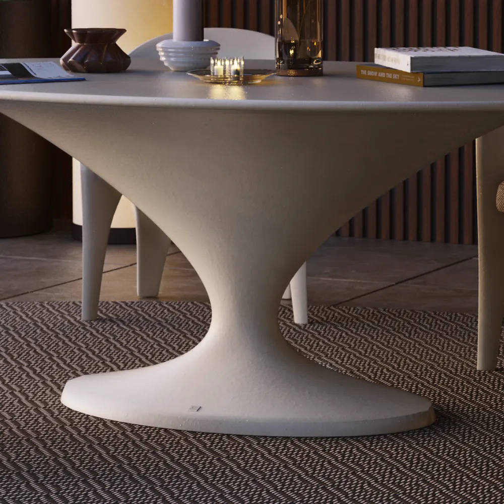 Pormenor da mesa de jantar Charm branca, com base central curva e transição contínua para o tampo oval.