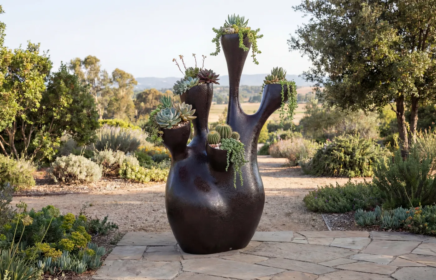 Coral planter in an outdoor garden, with a branched body, volcanic texture surface and plants placed in the upper openings.
