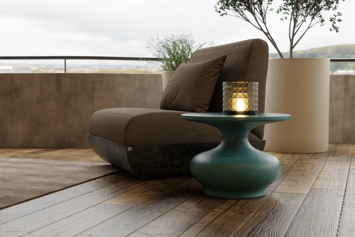 Doris outdoor side table in dark green, placed beside a lounge chair on a wooden deck.