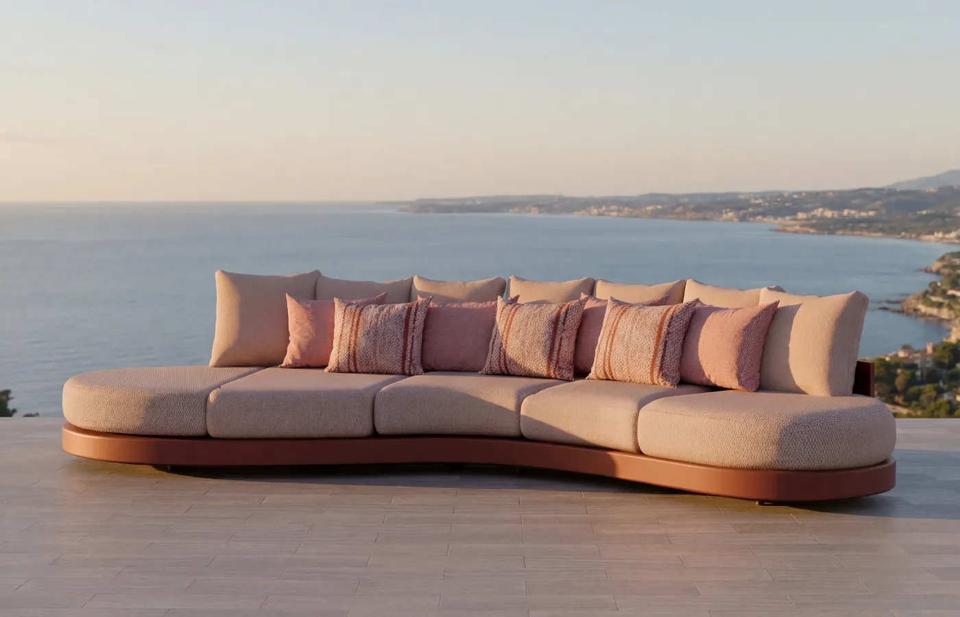 Harmony sofa in terracota color in an outdoor setting with panoramic sea views, highlighting its organic and comfortable design.