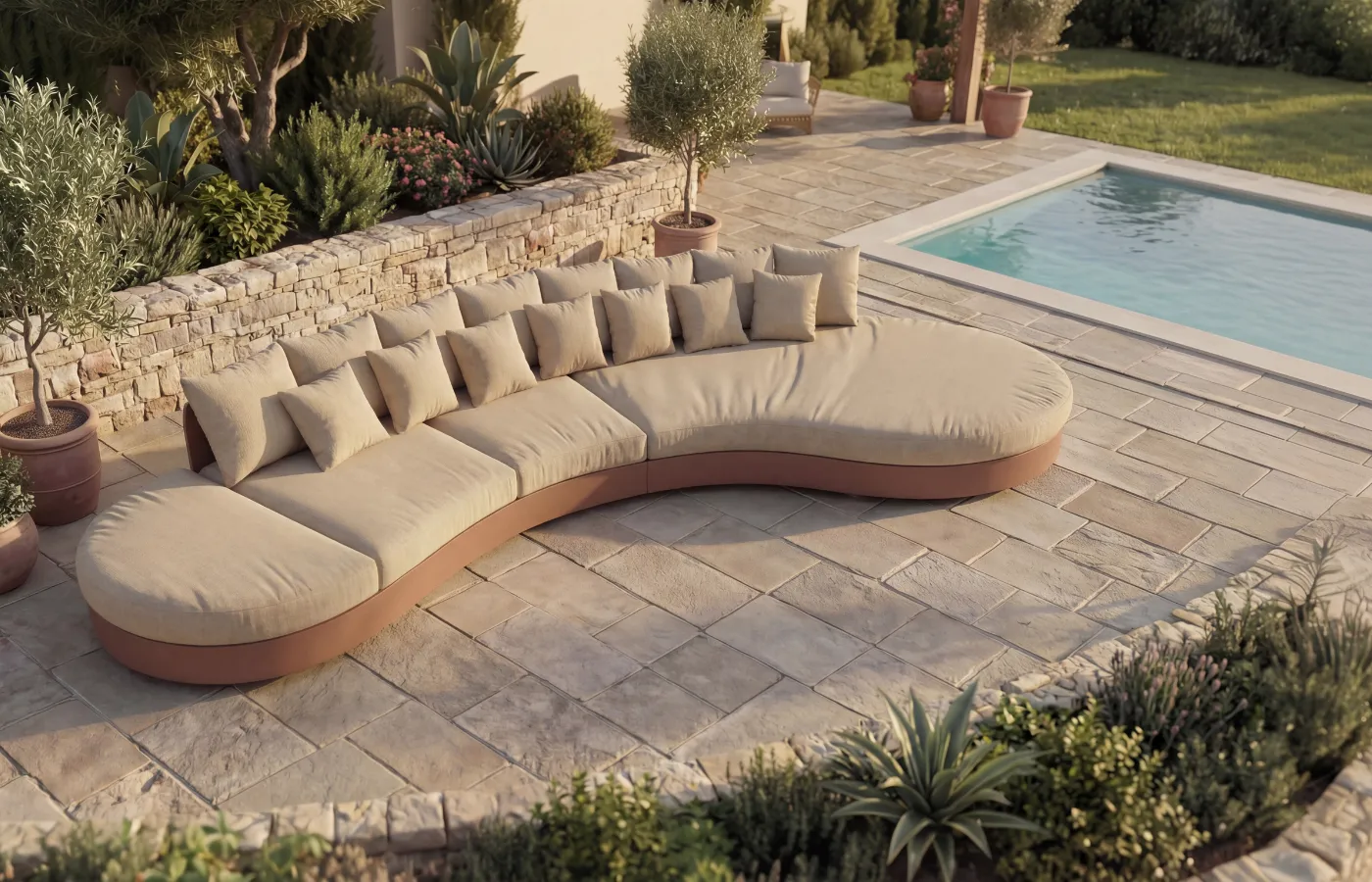 Curved terracota Harmony sofa on a terrace with pool, surrounded by mediterranean garden.