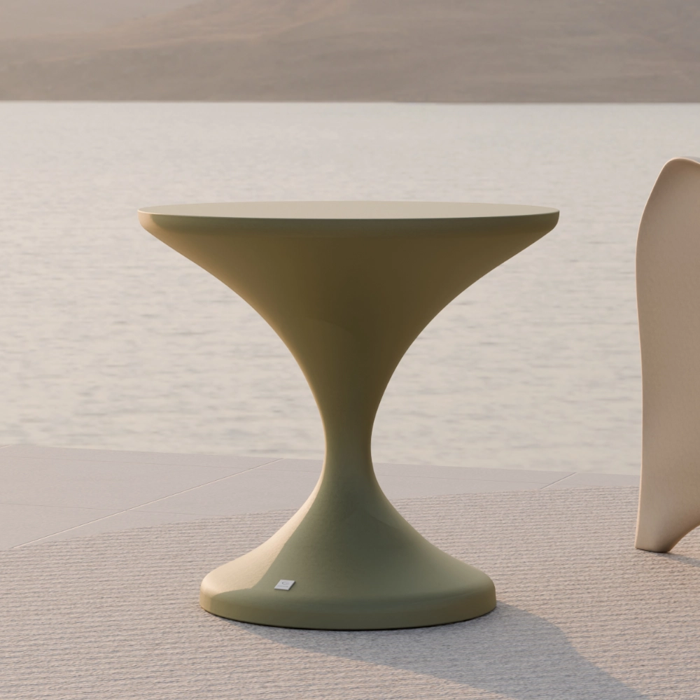 Close-up of the Lya outdoor side table in matte green, showing the round top and tapered central base.