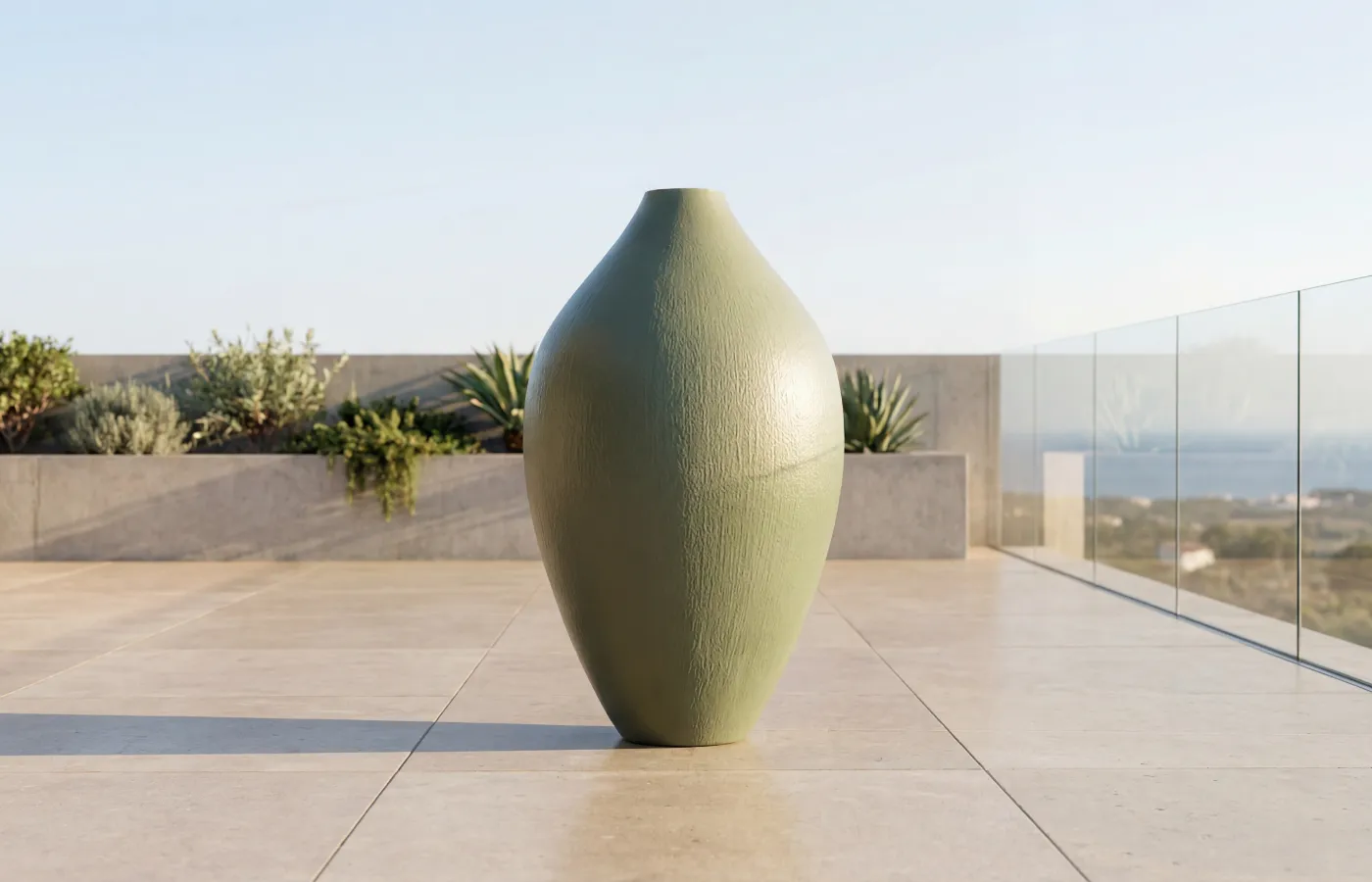 Nobel giant planter on an outdoor terrace, with a green textured elongated body and a narrow opening.