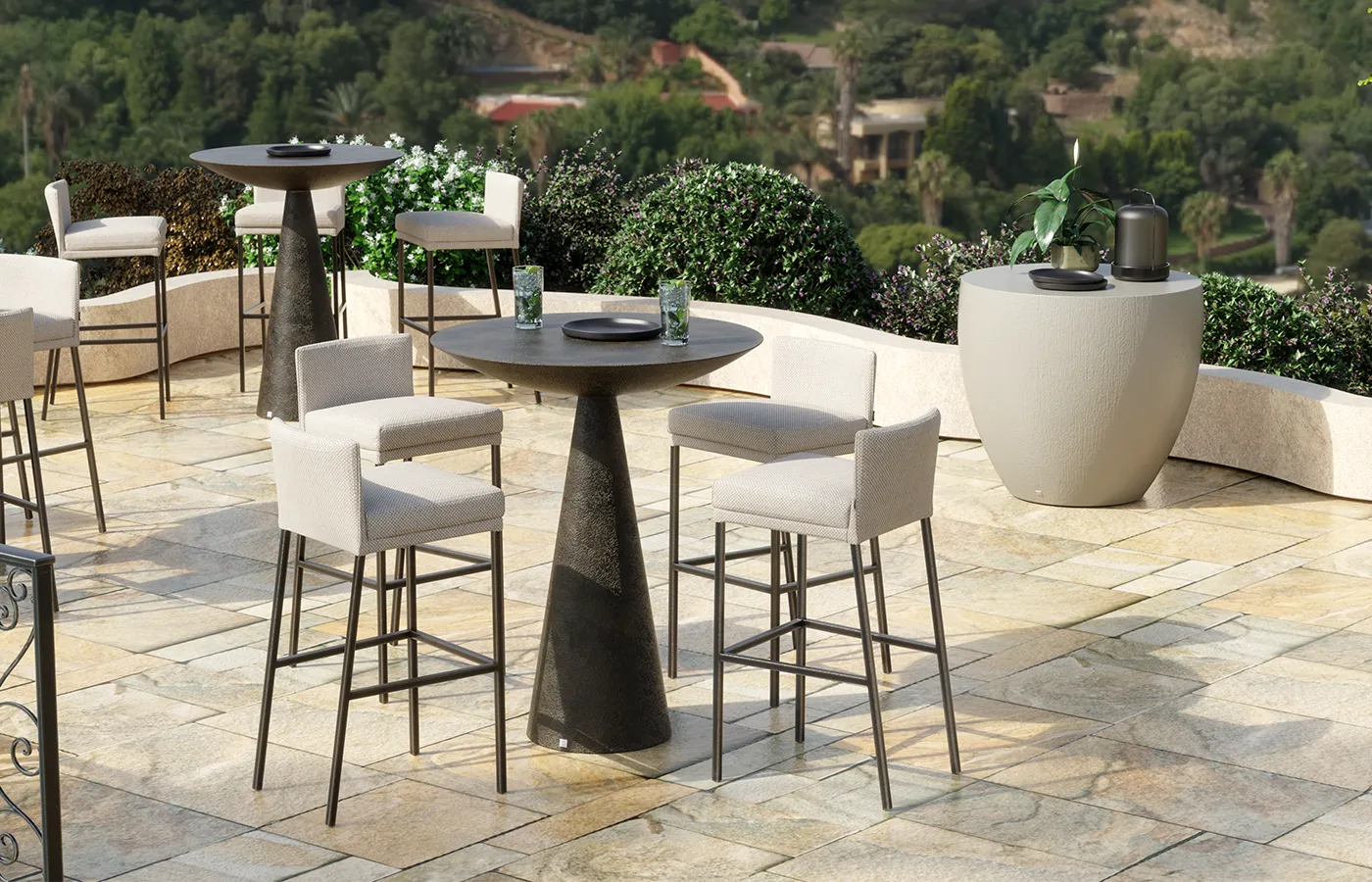 Terrace with Oceano bar tables featuring a volcanic-textured finish and high stools.