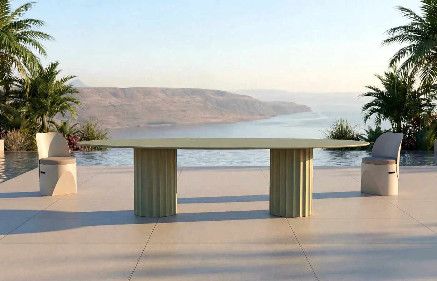 Roma oval outdoor dining table in soft green, with two fluted bases, set between two Cloe chairs by the pool.