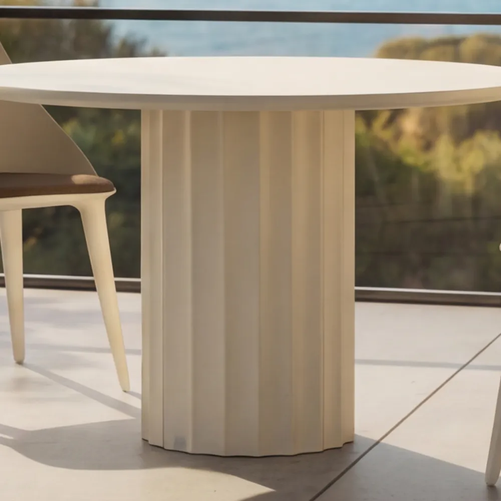 Detail of the Roma outdoor dining table in matte white, with a fluted base and slim top.