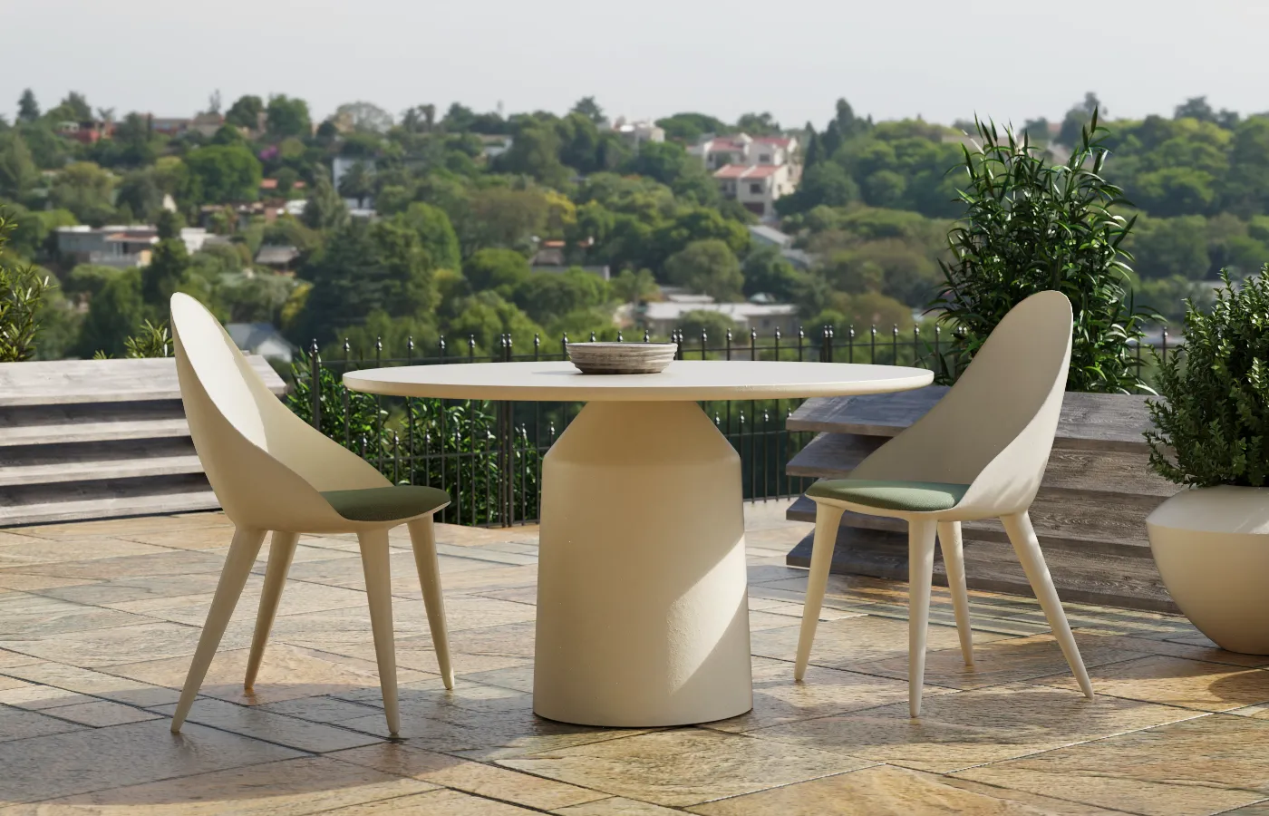 Siana round outdoor dining table in matte white, with a cylindrical central base, set between two Mónaco chairs on a terrace.