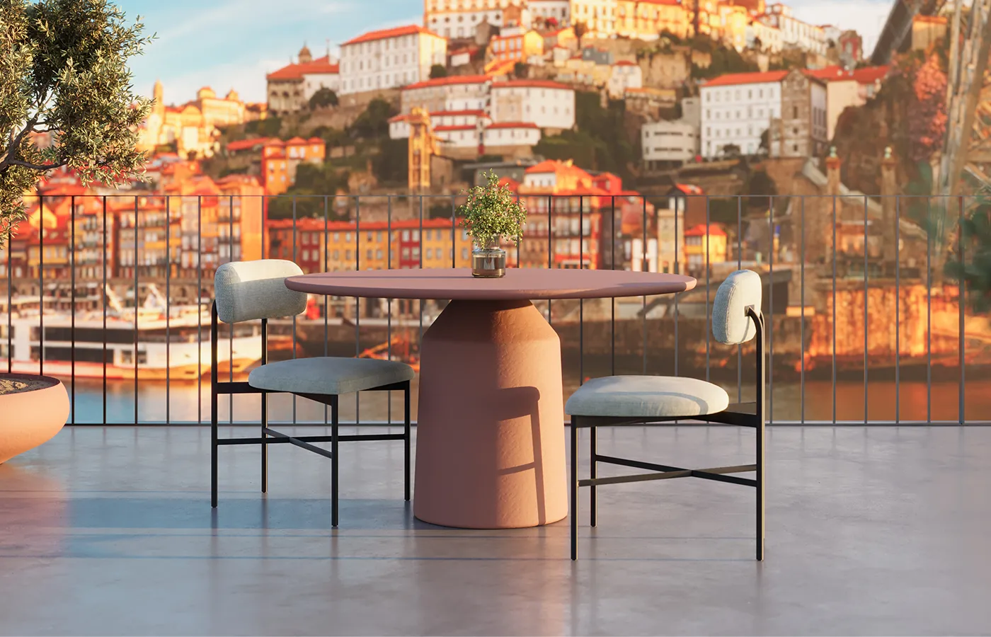 Siana round outdoor dining table in terracotta, set between two chairs on a terrace with an urban riverside view.