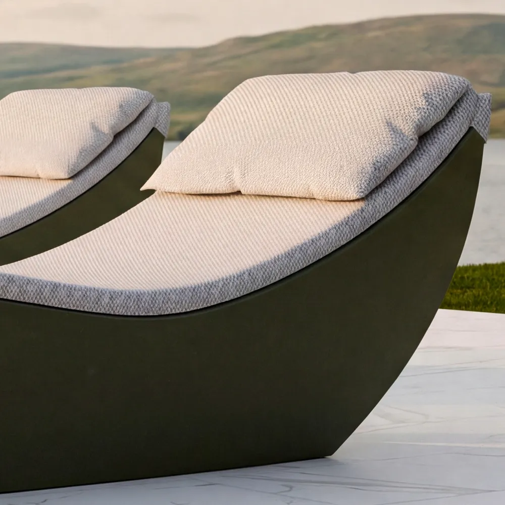 Close-up of the Spa chaise longue in green showing the curved cushion, headrest and visible surrounding base.
