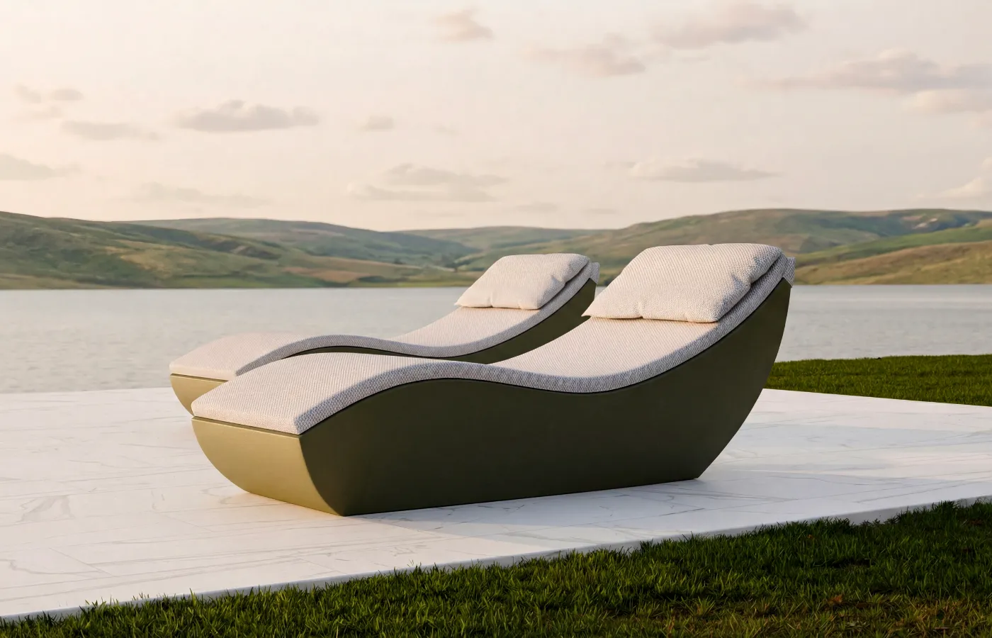 Spa chaise longues in green arranged by a lake and hills, with a continuous curved profile, headrest and surrounding base.