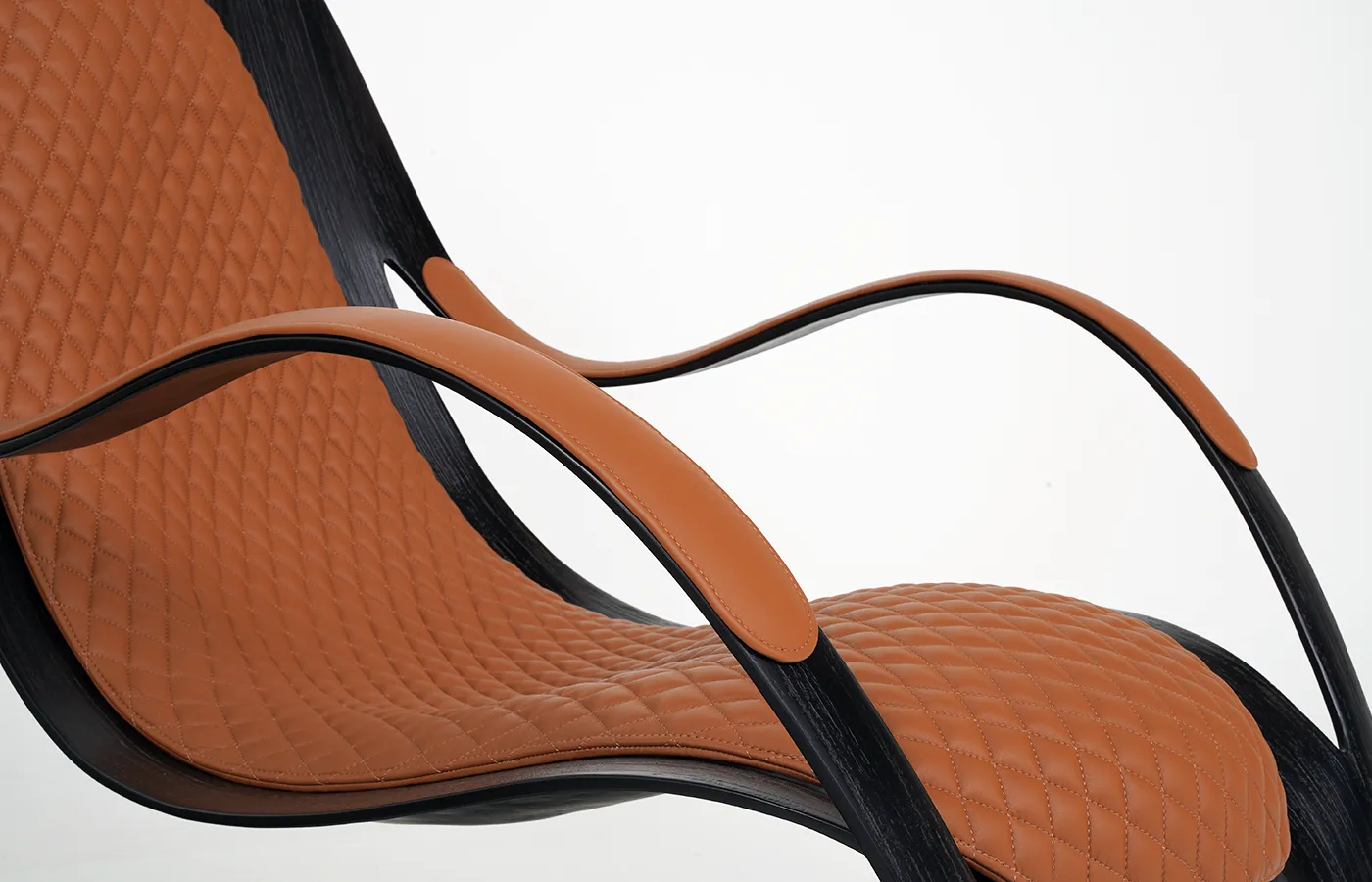 Close-up of the Coconut texture and Laguna “Brandy” Leather on the GANSK Flex armchair.