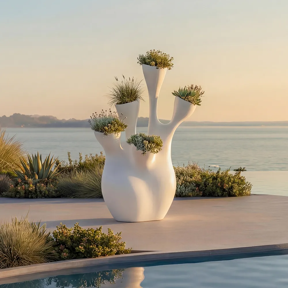 Outdoor pool area by the sea featuring a white Coral planter